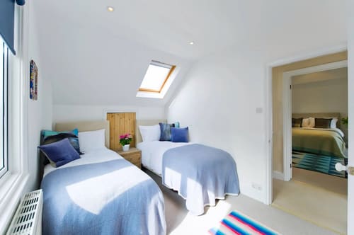 The Claygate Apartments, Claygate: Twin bedroom under a sloping ceiling with skylight