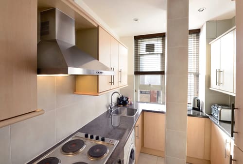 Hill St, W1K, Mayfair: Galley kitchen with electric hob and extractor