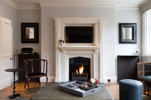 Prime Mayfair 2 bedroom, Mayfair: Living room with lit fireplace and TV above