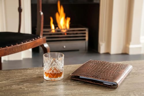 Prime Mayfair 2 bedroom, Mayfair: Glass of whisky beside a lit fireplace
