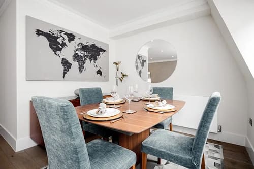 Mayfair Mews Apartment III, Mayfair: Dining table with blue velvet chairs and world map