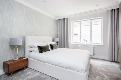 Mayfair Mews Apartment II, Mayfair: Double bedroom with white headboard and textured wallpaper