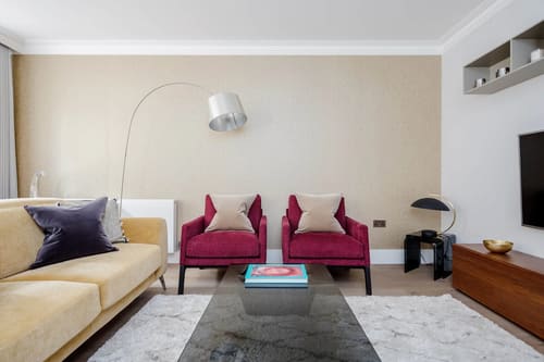 Mayfair Mews Apartment III, Mayfair: Living room with magenta armchairs and arc lamp