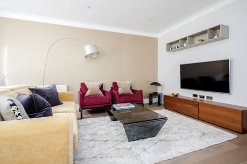 Mayfair Mews Apartment II, Mayfair: Living room with magenta armchairs and arc lamp