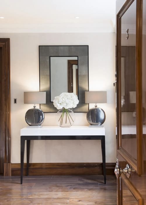 Grosvenor Hill, W1K, Mayfair: Console table with mirror, lamps and white flowers