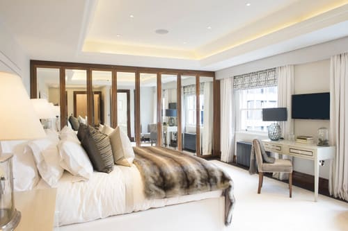 Grosvenor Hill, W1K, Mayfair: Bedroom with fur throw and mirrored wardrobes