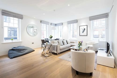 The Leicester Square Apartments, West End: Living room with white sofas and pale floor