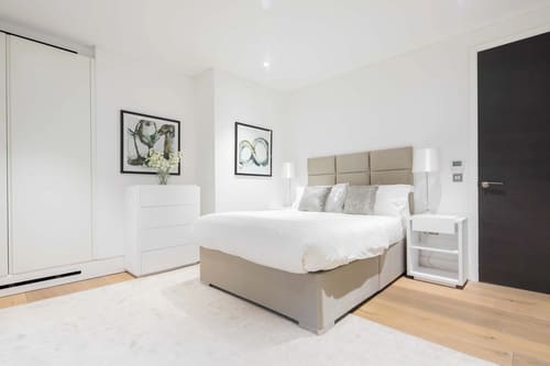 Dean St, Soho (2 bedroom Apartment), West End: Double bedroom with grey padded headboard