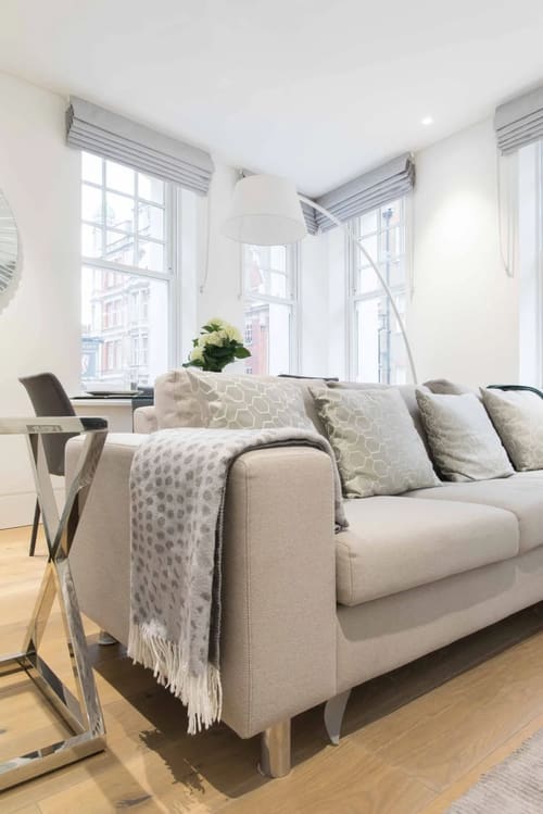 Dean St, Soho (2 bedroom Apartment), West End: Cream sofa with cushions by tall windows