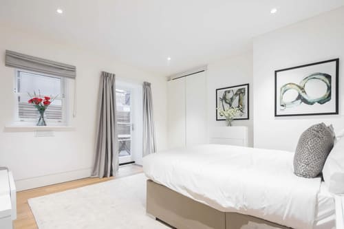 Dean St, Soho (2 bedroom Apartment), West End: Double bedroom with framed botanical prints