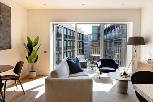 Ewer Street Apartments, Waterloo: Living room with sofa and balcony doors