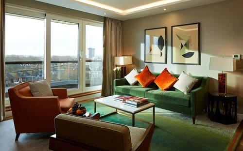 Gloucester Park, Kensington: Living room with green sofa and orange cushions