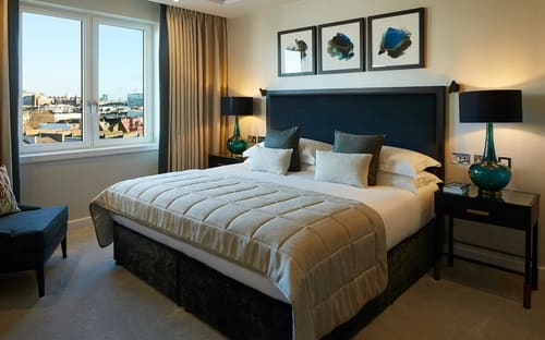 Gloucester Park, Kensington: Double bedroom with dark headboard and artwork