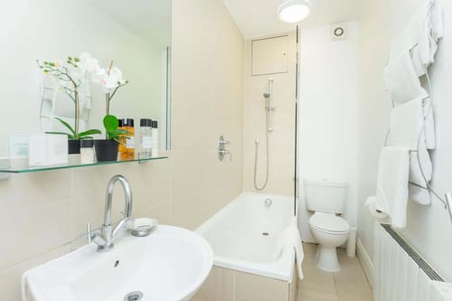 Picton Place, Mayfair: Bathroom with bath and orchid