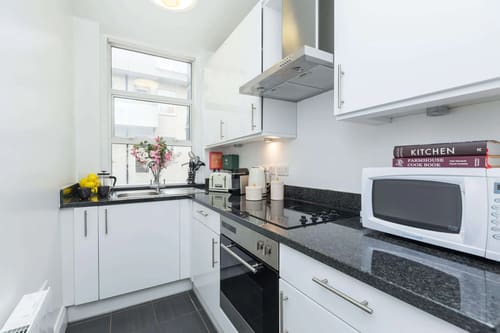 Picton Place, Mayfair: Kitchen with white units and black worktops