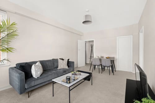 Dolphin House and Dolphin Square Apartments, Pimlico: Living room with grey sofa and dining area