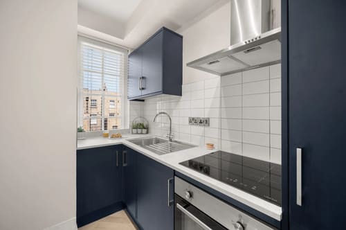 Dolphin House and Dolphin Square Apartments, Pimlico: Kitchen with navy units and white tiles