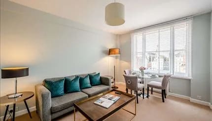 Hill St, W1K, Mayfair: Living room with teal cushions and dining area