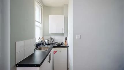 Hill St, W1K, Mayfair: Compact kitchen with sink and fridge