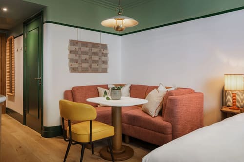 The July Apartments, Victoria: Coral banquette seating with round table