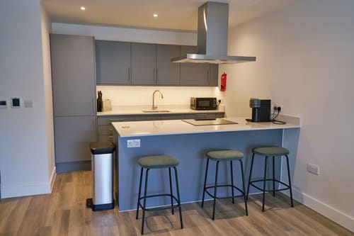 The Kings Cross Apartments, King's Cross: Kitchen with grey units, island and bar stools