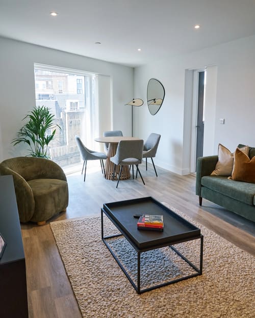 The Kings Cross Apartments, King's Cross: Living room with round mirror and dining table