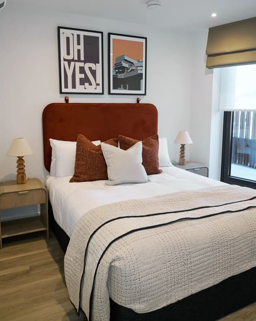The Kings Cross Apartments, King's Cross: Bed with rust velvet headboard