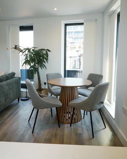 The Kings Cross Apartments, King's Cross: Round dining table with grey chairs and plant