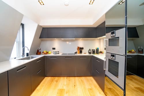 The Garrick Street Apartments, Covent Garden: Kitchen with dark grey units and wood floor