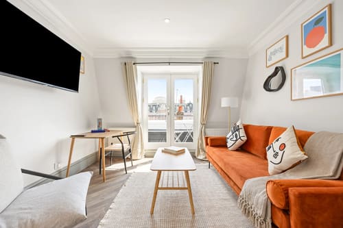 The Covent Garden Apartments, Covent Garden: Living room with orange sofa and French windows