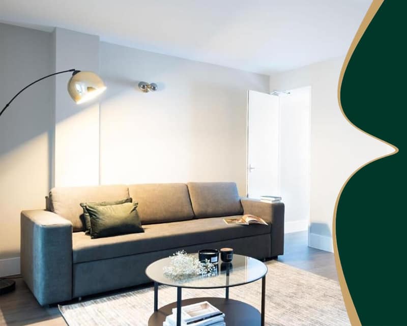 D'Montrio Fitzrovia, Fitzrovia: Grey sofa under an arched floor lamp