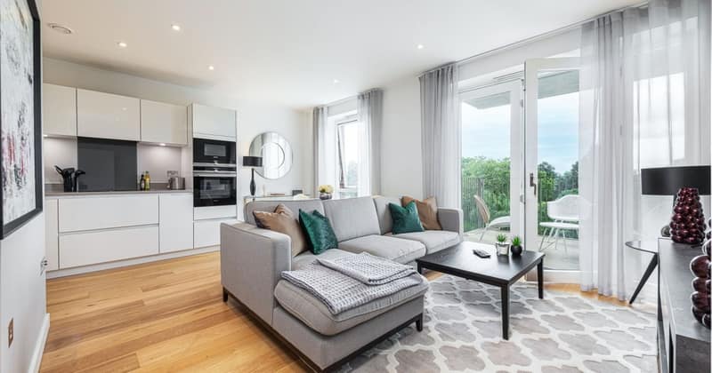 11 On Shoenix, Battersea: Grey sofa and pale rug beside dining area