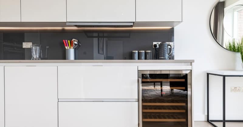 16 On Shoenix, Battersea: White kitchen cabinets with a built-in wine fridge