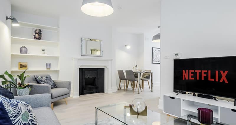 36A St Martin’s Lane Apartments, Covent Garden: White sitting room with dining table and television