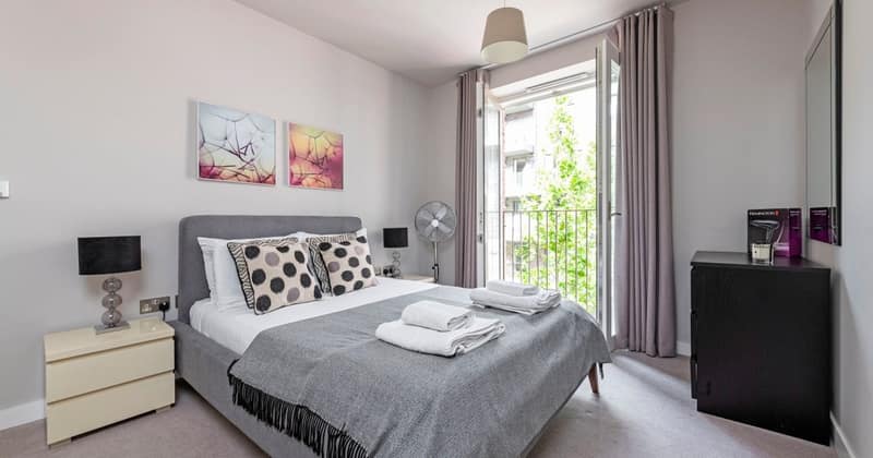 5 On Phoenix, Battersea: White bed beside balcony doors and framed artwork
