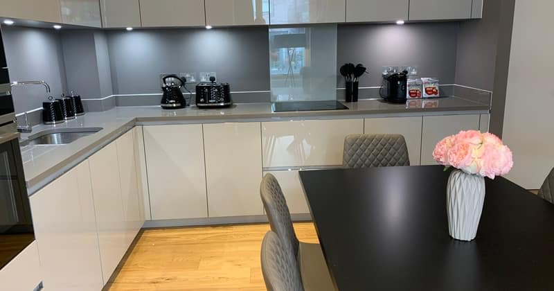 9 On Phoenix, Battersea: Dark kitchen cabinets beside dining table and flowers