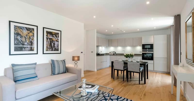Boutique On Sphinx, Battersea: Pale-blue sofa beside kitchen and dining table