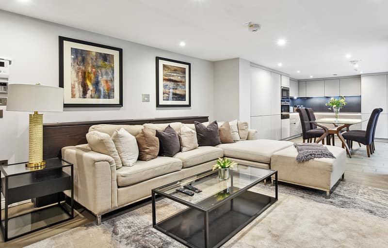 Buckingham Gate, Westminster: Grey sofas around a low glass coffee table