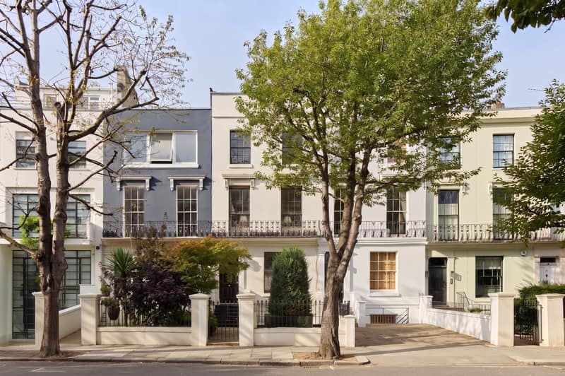 Chepstow Crescent, Notting Hill: White townhouse frontage behind trees and railings