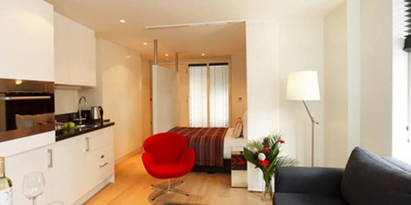 Crane Court Apartments, Holborn: Kitchen and breakfast counter beside a grey sofa