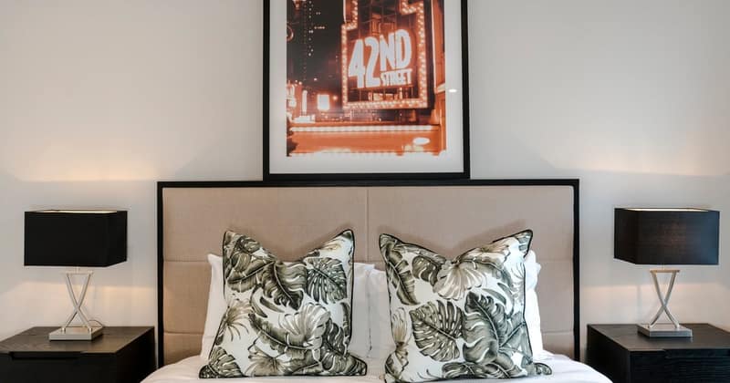 Modern Apartment Chelsea, Chelsea: White sofa with patterned cushions beneath framed artwork
