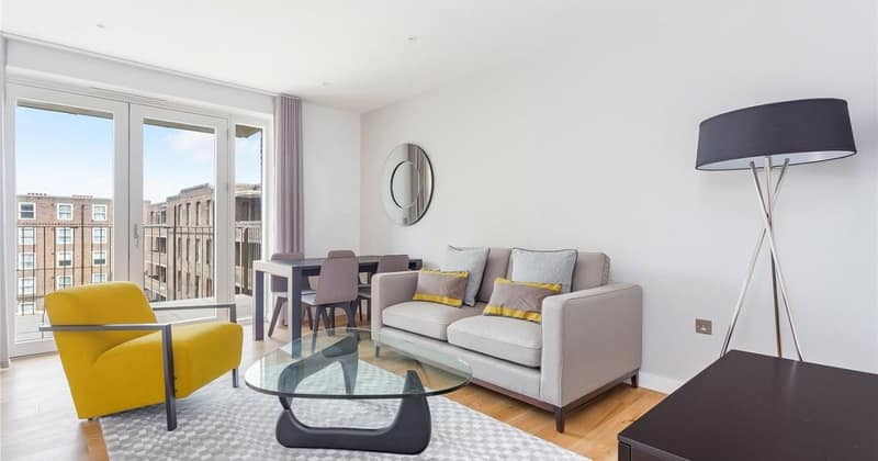 Spacious 2 Bed Apartment, Battersea: Grey sofa and yellow armchair by large windows