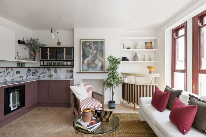 Talbot Road, Notting Hill: Sitting room with artwork and red sofa cushions