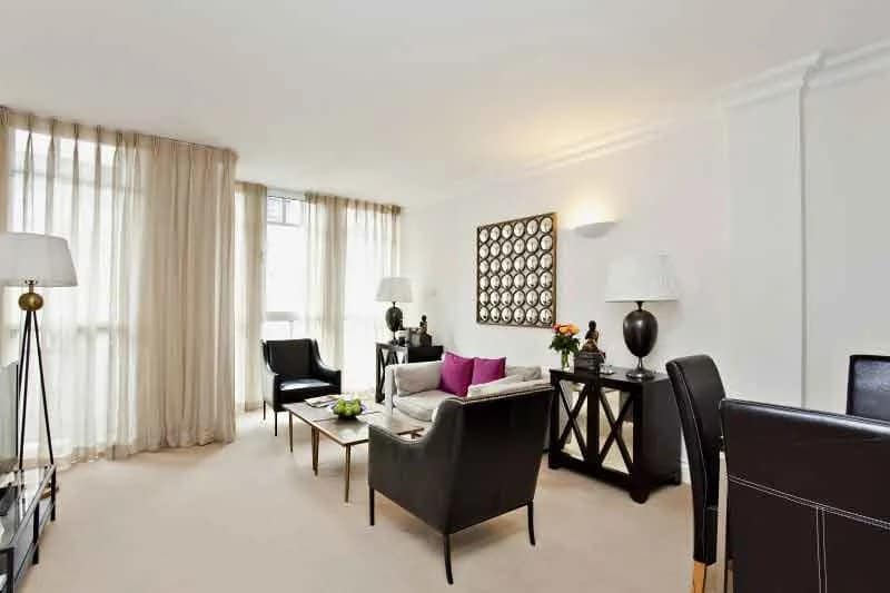 Westminster St John’s Gardens Apartments, Westminster: White sofas beside dining table and tall windows