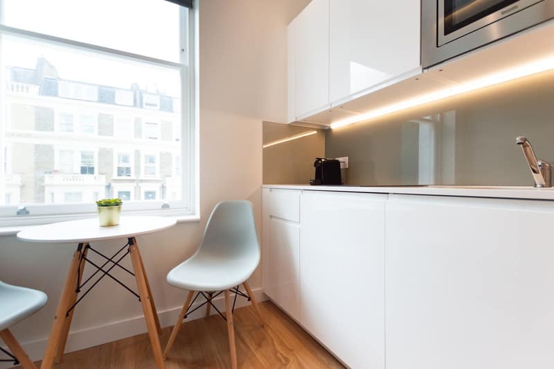 Earl’s Court East & West Apartments, Earl's Court: Studio dining table beside fitted kitchen counter