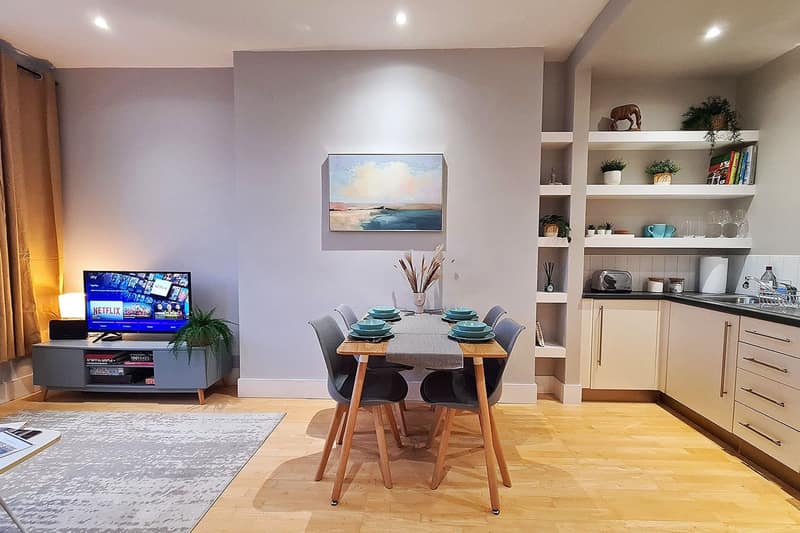 Habitatia Sinclair Road Apartment, Kensington: Living room with television and white display shelves