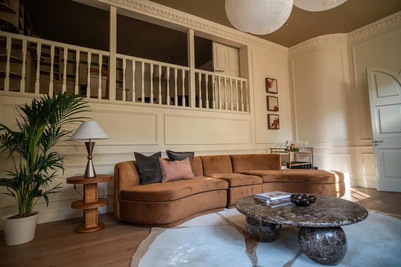 Melbury Cottage, Kensington: Double-height sitting room with wooden mezzanine railing