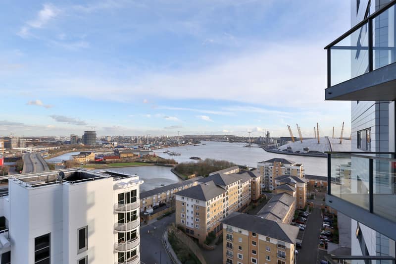 Neutron Tower One Bedroom Apartment, East London: Balcony overlooking riverside buildings and water