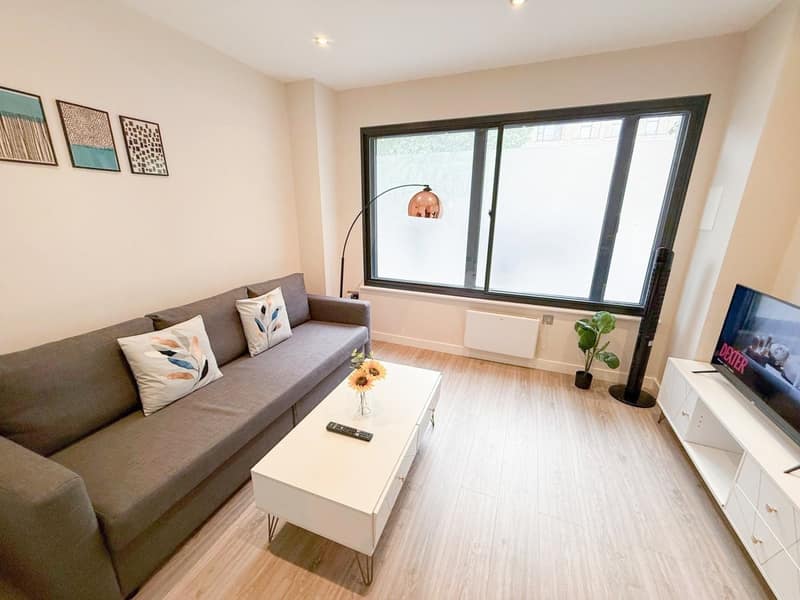 New Kent Road One Bedroom Apartment, London: Living room with sofa and glass coffee table