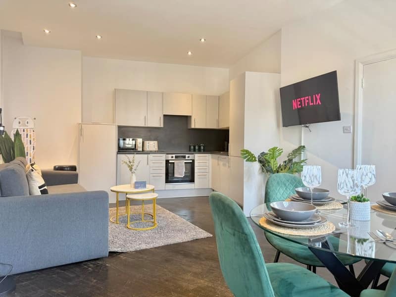 Old Street Apartment Two, Shoreditch: Living room with grey sofa and wall-mounted television